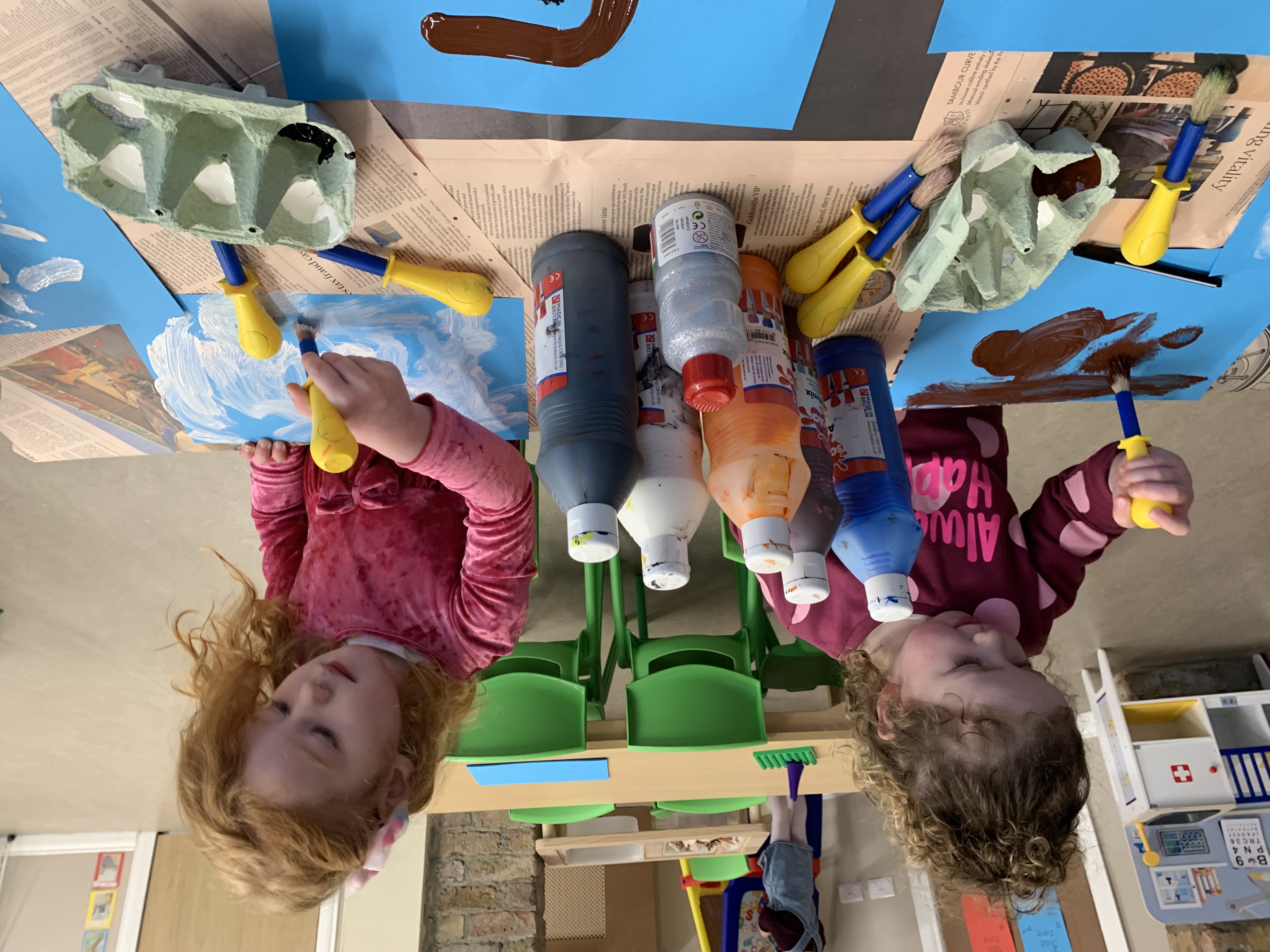 Children painting pictures together